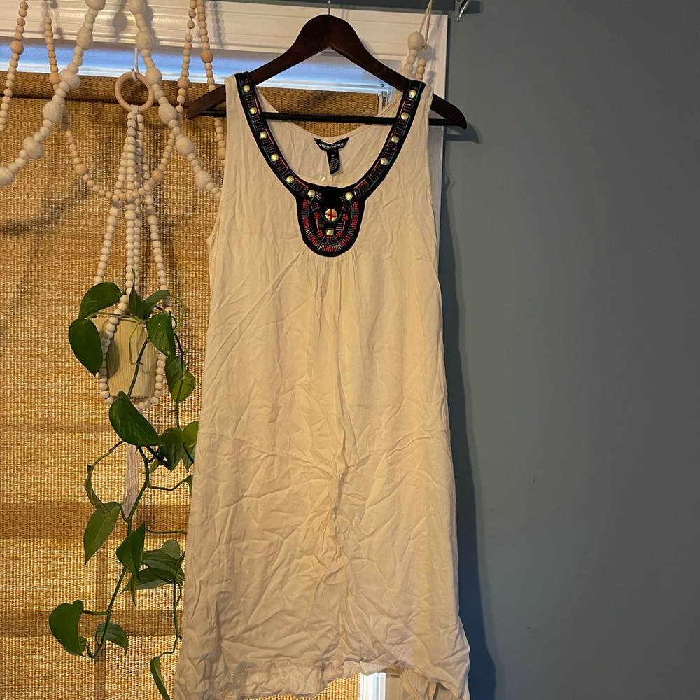 Cute, light, airy summer dress cream color with sequin neck line.
